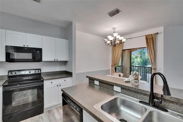 2220 Chianti Pl Unit 8-0828, Palm Harbor, FL 34683 - kitchen with black appliances, a sink, a chandelier, dark countertops, and white cabinets