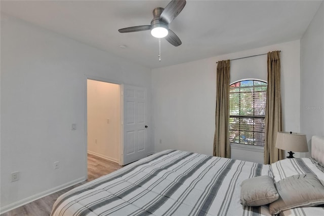 2220 Chianti Pl Unit 8-0828, Palm Harbor, FL 34683 - bedroom with light wood-style floors, baseboards, and ceiling fan