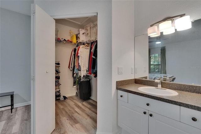 2220 Chianti Pl Unit 8-0828, Palm Harbor, FL 34683 - ensuite bathroom with wood finished floors, a spacious closet, and vanity