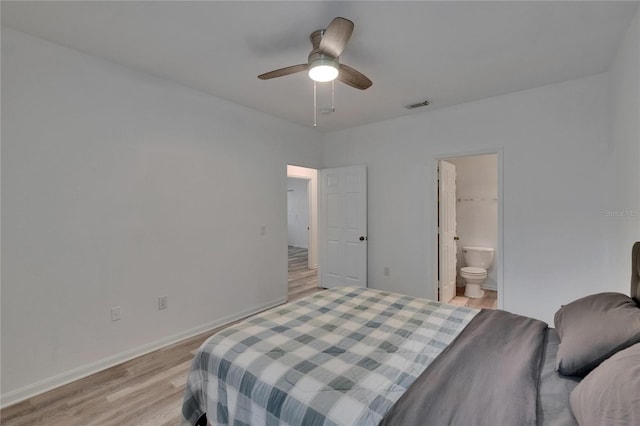2220 Chianti Pl Unit 8-0828, Palm Harbor, FL 34683 - bedroom with light wood-style flooring, ensuite bath, baseboards, and ceiling fan
