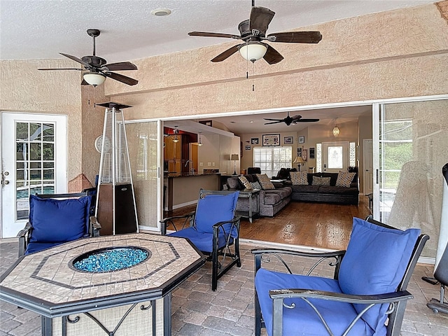 3001 Regal Oaks Blvd, Palm Harbor, FL 34684 - view of patio featuring a ceiling fan and a fire pit