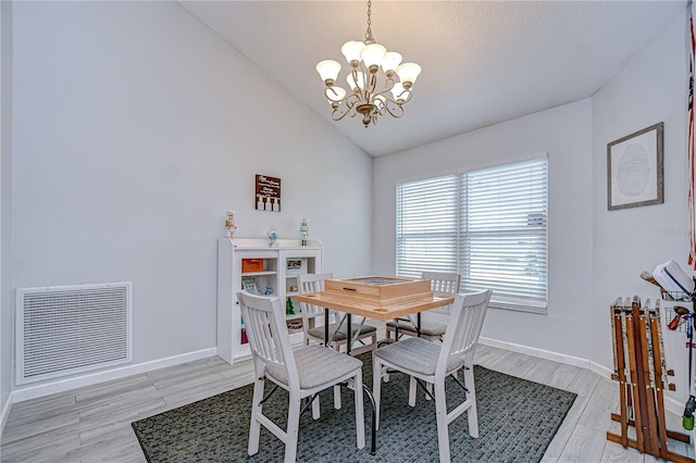 2020 Elk Spring Dr, Brandon, FL 33511 - dining room with a chandelier, light wood-style flooring, vaulted ceiling, and baseboards