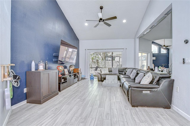 2020 Elk Spring Dr, Brandon, FL 33511 - living room with a ceiling fan, light wood-style flooring, baseboards, plenty of natural light, and high vaulted ceiling