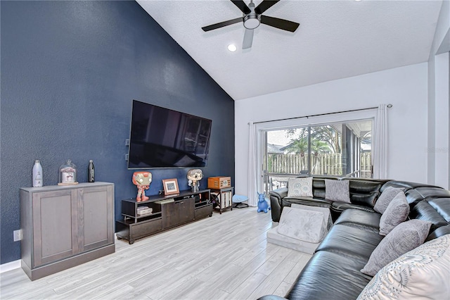 2020 Elk Spring Dr, Brandon, FL 33511 - living room featuring light wood-style floors, ceiling fan, high vaulted ceiling, and a textured ceiling
