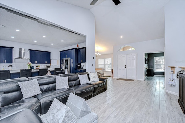 2020 Elk Spring Dr, Brandon, FL 33511 - living area with ceiling fan, lofted ceiling, light wood-style floors, a chandelier, and recessed lighting