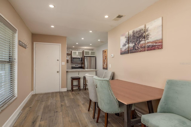 1250 S Pinellas Ave Unit 214, Tarpon Springs, FL 34689 - dining room featuring wood finished floors, recessed lighting, and baseboards