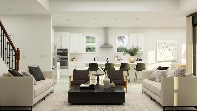 living area featuring stairway and light wood-style floors