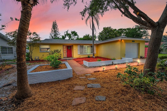 2485 Indigo Dr, Clearwater, FL 33763 - view of front of home with stucco siding and an attached garage