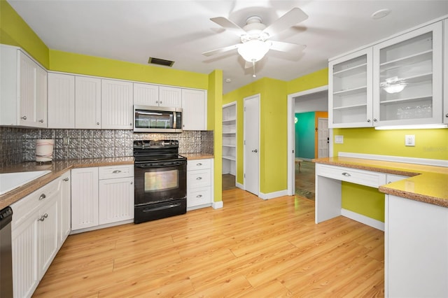 2485 Indigo Dr, Clearwater, FL 33763 - kitchen featuring appliances with stainless steel finishes, tasteful backsplash, white cabinetry, and light wood-type flooring