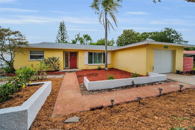 2485 Indigo Dr, Clearwater, FL 33763 - view of front of property featuring stucco siding, a garage, and concrete driveway