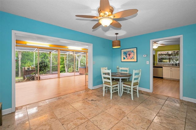 2485 Indigo Dr, Clearwater, FL 33763 - dining room with stone tile floors, healthy amount of natural light, ceiling fan, and a textured ceiling