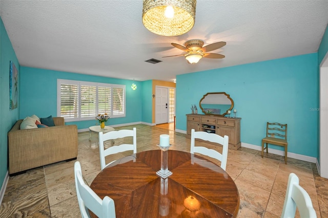 2485 Indigo Dr, Clearwater, FL 33763 - dining room with ceiling fan, baseboards, and a textured ceiling