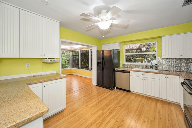 2485 Indigo Dr, Clearwater, FL 33763 - kitchen featuring stainless steel dishwasher, black refrigerator with ice dispenser, range with electric cooktop, and healthy amount of natural light