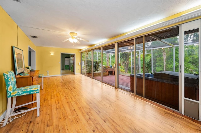 2485 Indigo Dr, Clearwater, FL 33763 - unfurnished sunroom with a ceiling fan, a jacuzzi, and healthy amount of natural light