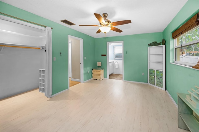 2485 Indigo Dr, Clearwater, FL 33763 - unfurnished bedroom with wood finished floors, baseboards, and ceiling fan