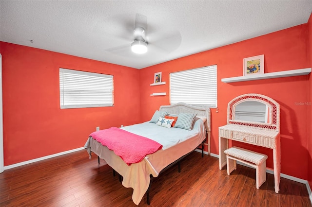 2485 Indigo Dr, Clearwater, FL 33763 - bedroom featuring a textured ceiling, baseboards, wood finished floors, and ceiling fan