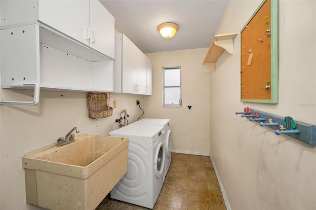 2485 Indigo Dr, Clearwater, FL 33763 - laundry area with cabinet space, washer and clothes dryer, and baseboards