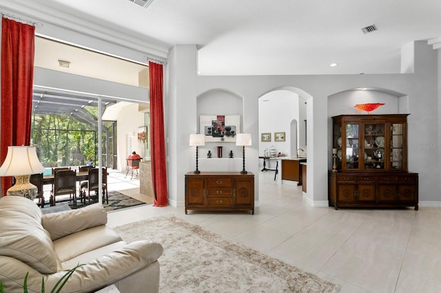 17318 Emerald Chase Dr, Tampa, FL 33647 - living room with arched walkways, light tile patterned floors, recessed lighting, and baseboards
