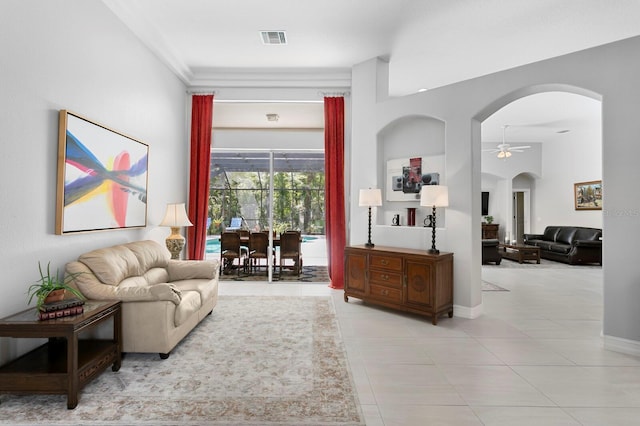 17318 Emerald Chase Dr, Tampa, FL 33647 - tiled living area featuring arched walkways, a ceiling fan, and baseboards