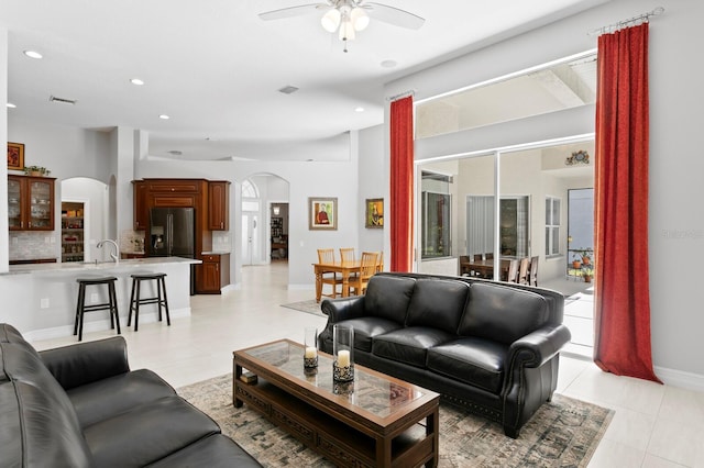 17318 Emerald Chase Dr, Tampa, FL 33647 - living area with arched walkways, a ceiling fan, light tile patterned floors, recessed lighting, and baseboards