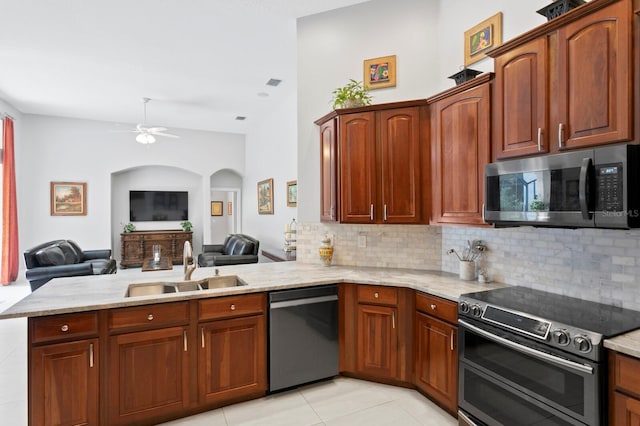 17318 Emerald Chase Dr, Tampa, FL 33647 - kitchen featuring stainless steel appliances, ceiling fan, a sink, tasteful backsplash, and light stone counters