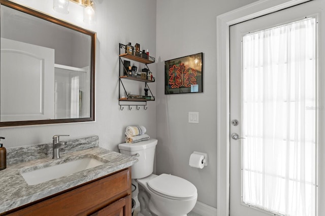 17318 Emerald Chase Dr, Tampa, FL 33647 - full bathroom with vanity, toilet, baseboards, and a shower