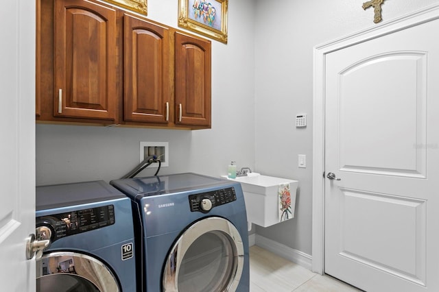 17318 Emerald Chase Dr, Tampa, FL 33647 - clothes washing area featuring washing machine and dryer, cabinet space, light tile patterned floors, and baseboards