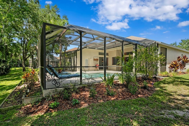 17318 Emerald Chase Dr, Tampa, FL 33647 - rear view of house featuring an outdoor pool, a patio area, a yard, glass enclosure, and stucco siding