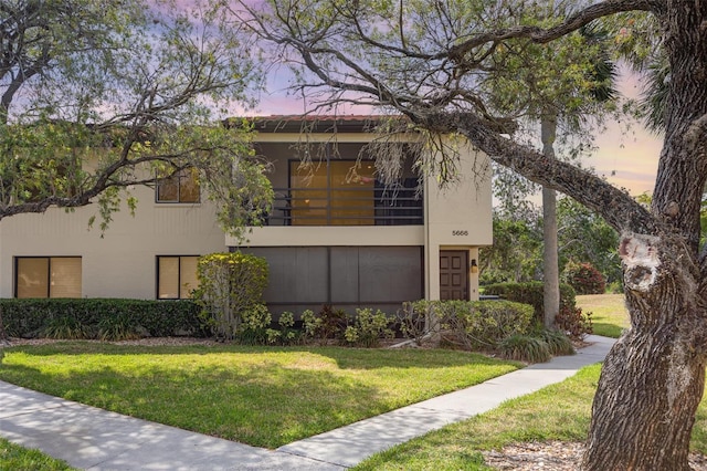 5666 Gardens Dr Unit 202, Sarasota, FL 34243 - view of side of property featuring a lawn and a balcony