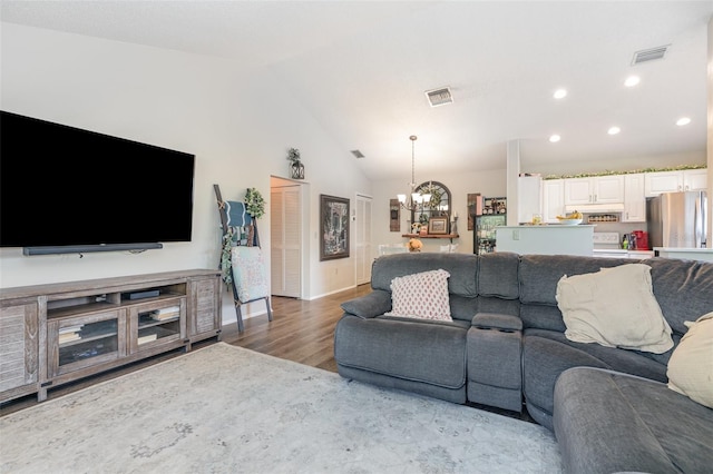 5666 Gardens Dr Unit 202, Sarasota, FL 34243 - living area featuring a chandelier, wood finished floors, vaulted ceiling, recessed lighting, and baseboards
