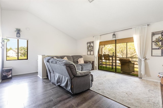 5666 Gardens Dr Unit 202, Sarasota, FL 34243 - living area featuring dark wood finished floors, vaulted ceiling, and baseboards