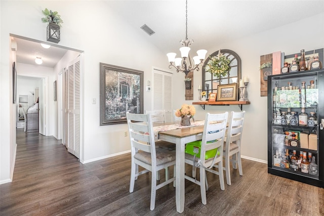 5666 Gardens Dr Unit 202, Sarasota, FL 34243 - dining area featuring a chandelier, wood finished floors, baseboards, and vaulted ceiling