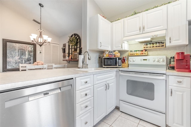 5666 Gardens Dr Unit 202, Sarasota, FL 34243 - kitchen featuring appliances with stainless steel finishes, under cabinet range hood, a sink, light countertops, and a chandelier