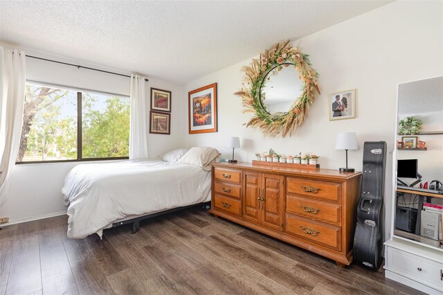 5666 Gardens Dr Unit 202, Sarasota, FL 34243 - bedroom featuring dark wood-type flooring and a textured ceiling