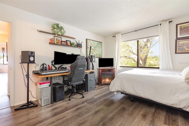 5666 Gardens Dr Unit 202, Sarasota, FL 34243 - bedroom with wood finished floors, a desk, and a textured ceiling