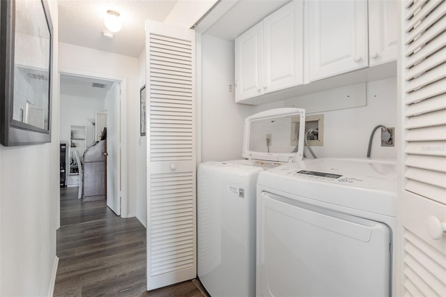 5666 Gardens Dr Unit 202, Sarasota, FL 34243 - laundry area with cabinet space, washer and dryer, dark wood finished floors, and baseboards