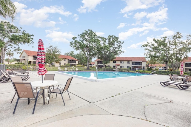 5666 Gardens Dr Unit 202, Sarasota, FL 34243 - community pool featuring a patio and fence