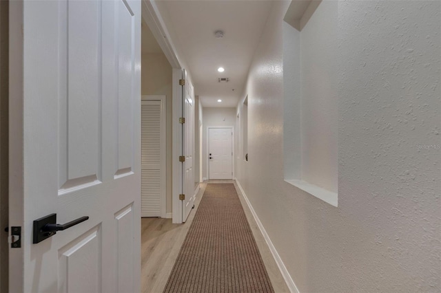 330 Lang Ct N Unit 1, Saint Petersburg, FL 33701 - corridor featuring light wood finished floors, a textured wall, recessed lighting, and baseboards