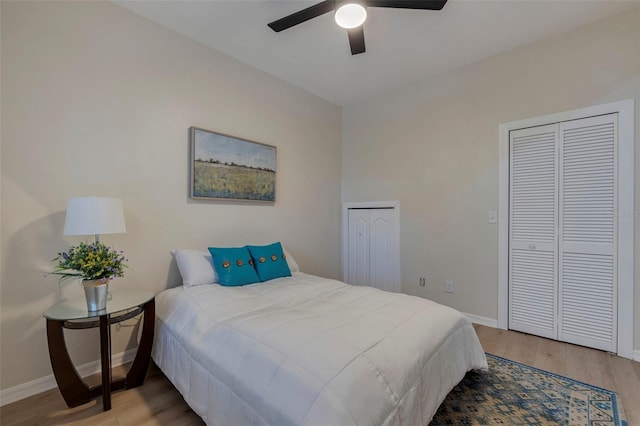 330 Lang Ct N Unit 1, Saint Petersburg, FL 33701 - bedroom featuring two closets, wood finished floors, baseboards, and ceiling fan