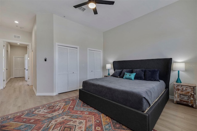 330 Lang Ct N Unit 1, Saint Petersburg, FL 33701 - bedroom with multiple closets, light wood finished floors, baseboards, a ceiling fan, and a towering ceiling