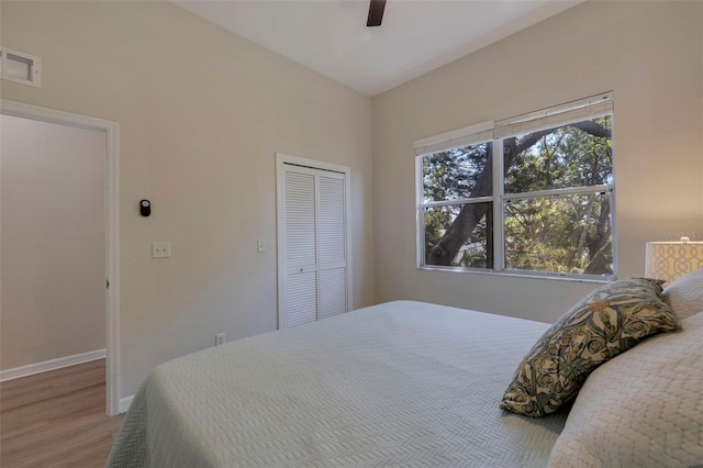 330 Lang Ct N Unit 1, Saint Petersburg, FL 33701 - bedroom with light wood finished floors, baseboards, a closet, and a ceiling fan