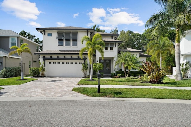 12705 Green Heron Way, Odessa, FL 33556 - view of front of property with stucco siding, an attached garage, decorative driveway, and a front yard