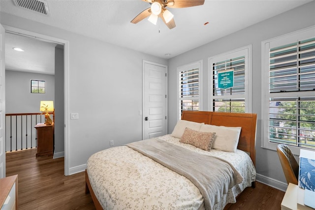 12705 Green Heron Way, Odessa, FL 33556 - bedroom with baseboards, wood finished floors, and multiple windows
