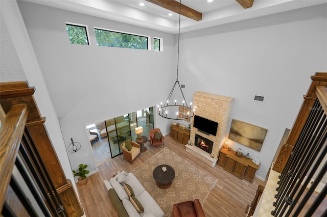 12705 Green Heron Way, Odessa, FL 33556 - living area with a towering ceiling, a stone fireplace, wood finished floors, recessed lighting, and a chandelier