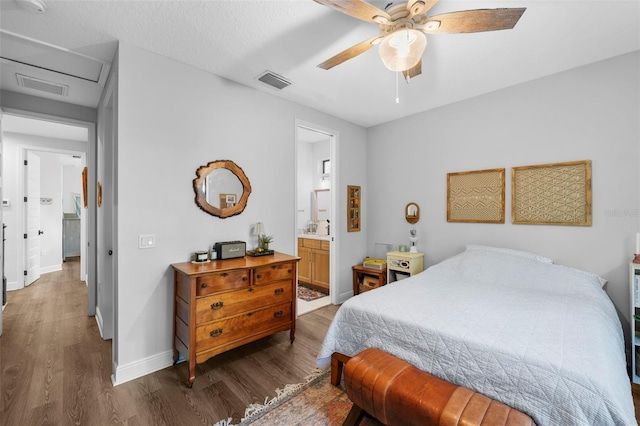 12705 Green Heron Way, Odessa, FL 33556 - bedroom with wood finished floors, baseboards, attic access, and ensuite bathroom