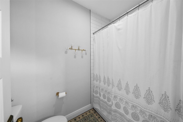 12705 Green Heron Way, Odessa, FL 33556 - bathroom with toilet, a shower with curtain, and baseboards