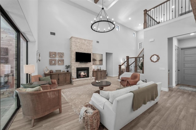 12705 Green Heron Way, Odessa, FL 33556 - living area featuring a high ceiling, stairway, a chandelier, light wood-style flooring, and baseboards