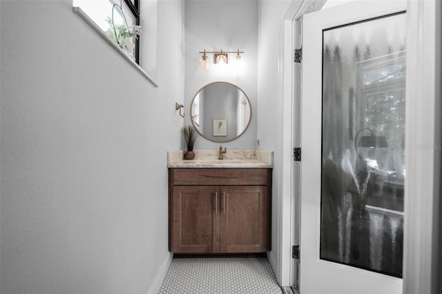 12705 Green Heron Way, Odessa, FL 33556 - bathroom featuring baseboards, vanity, tile patterned floors, and healthy amount of natural light