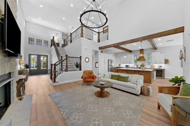 12705 Green Heron Way, Odessa, FL 33556 - living area featuring beverage cooler, stairs, french doors, light wood finished floors, and recessed lighting