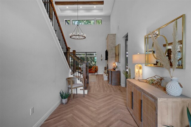12705 Green Heron Way, Odessa, FL 33556 - foyer with stairway, baseboards, a towering ceiling, a chandelier, and healthy amount of natural light
